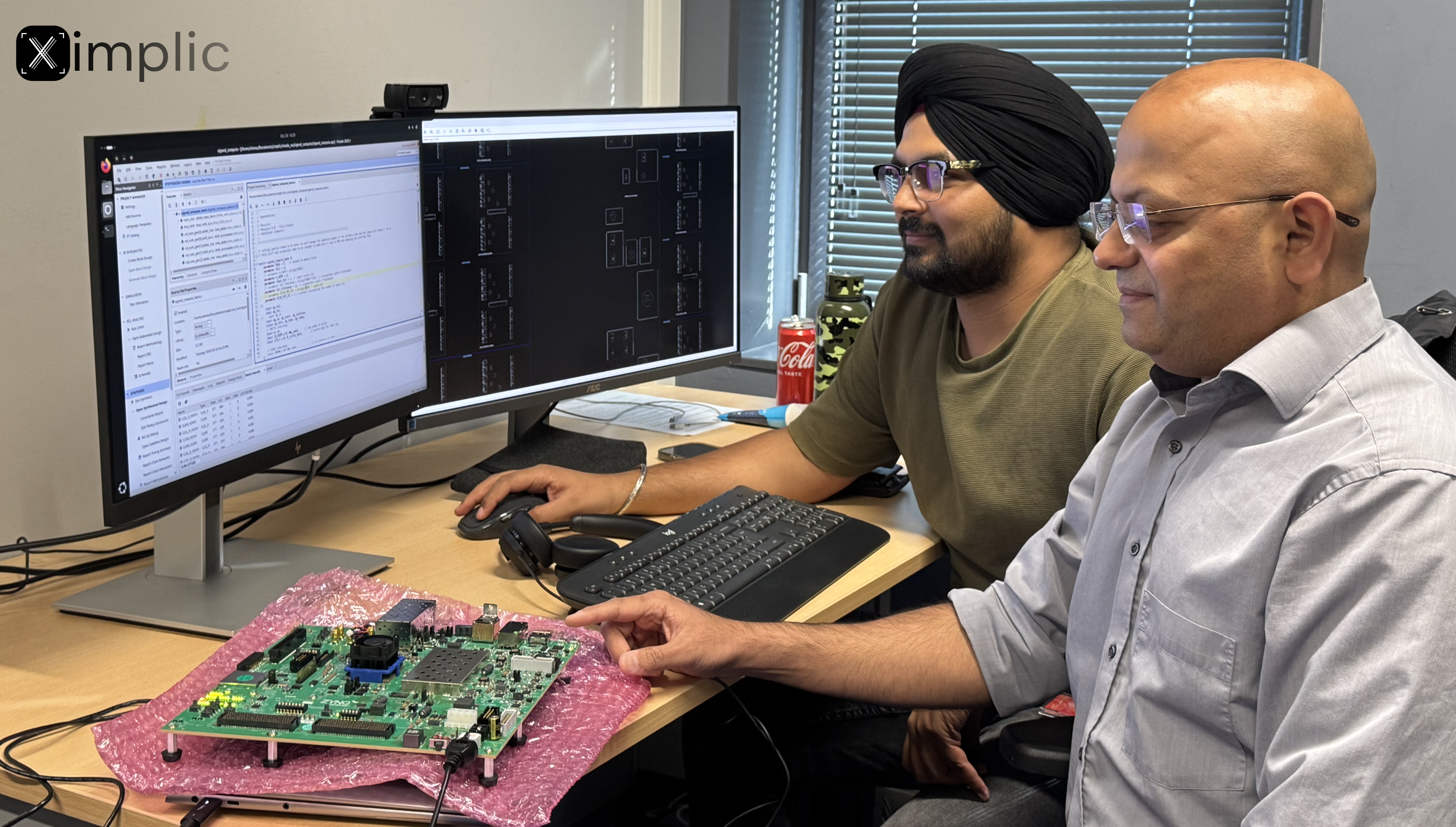 Farhad Merchant and Simranjeet Singh in front of a computer screen with a hardware board next to them