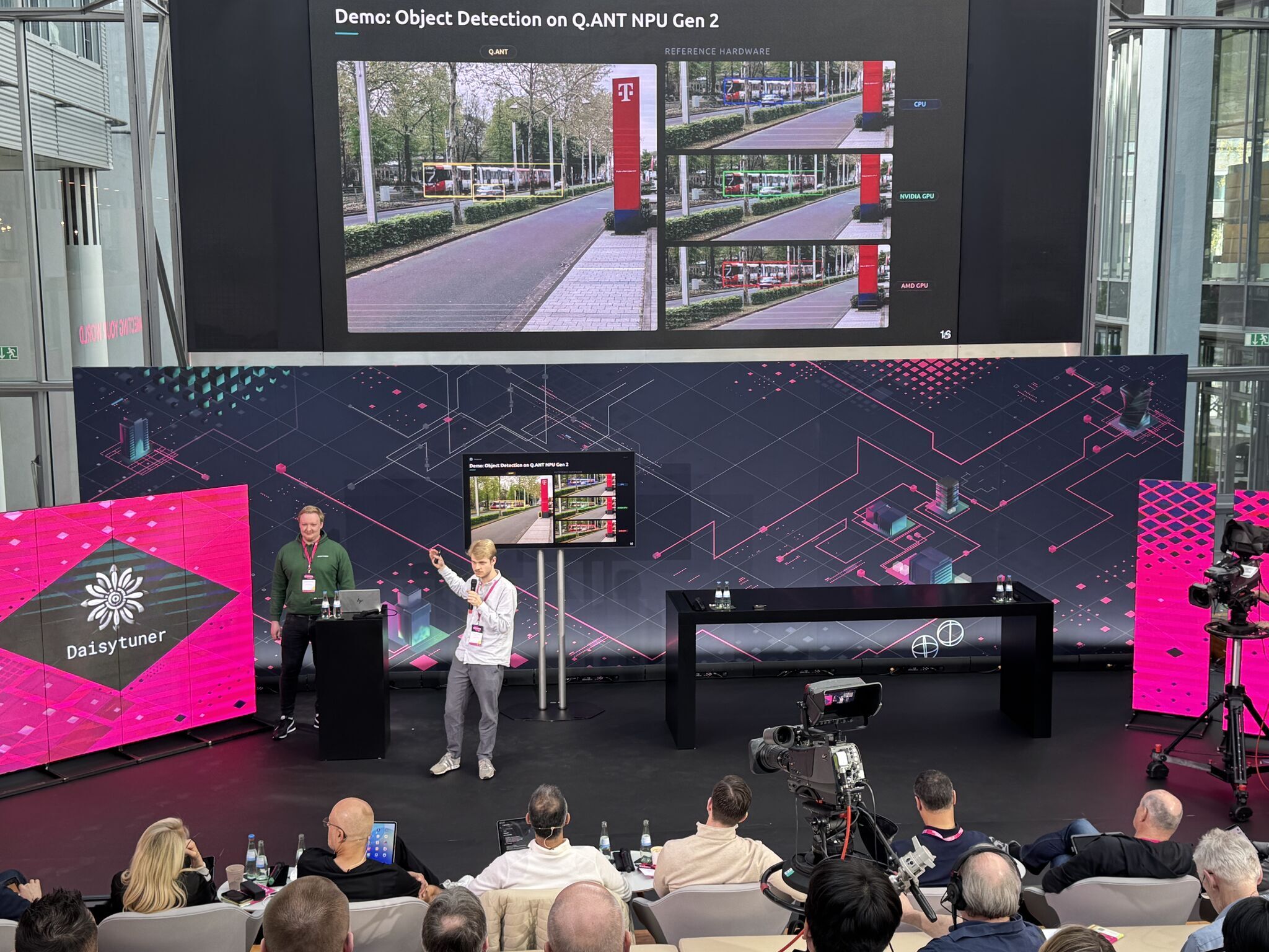Daisytuner's Adrian Schmitz and Moritz Timmer conducting a live demonstration of Daisytuner's technology on stage at the T-Challenge finals