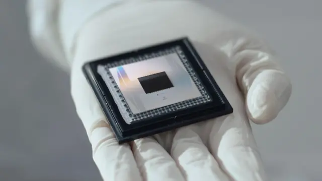 Figure 1: Google's 105 qubit Willow Chip which achieved exponential error reduction, produced in 2024. [BBC-Willow]